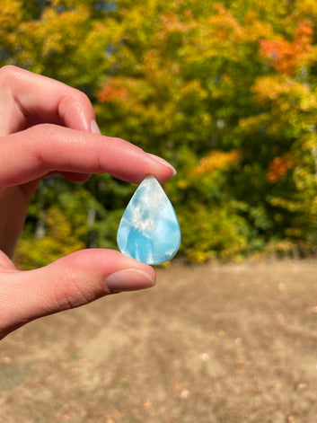 Light blue with soft white lines, tear drop in shape with polished surface. It has effects on four of the seven Chakras
