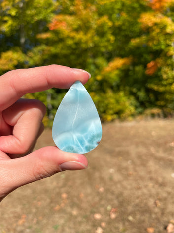Light blue with soft white lines, Tear drop in shape, with polished surface. It has effects on four of the seven Chakras.