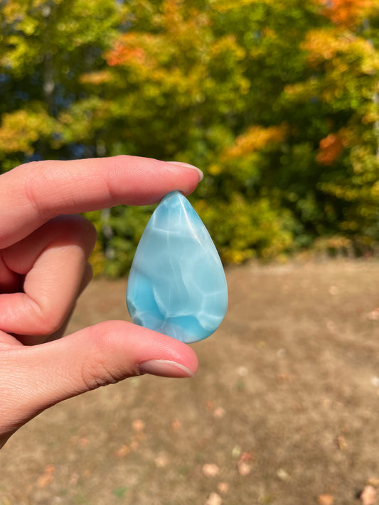 Light blue with soft white lines, Tear drop in shape, with polished surface. It has effects on four of the seven Chakras.