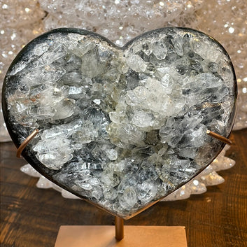 Pink Amethyst druzy hearts on custom metal stands, adorned with transparent crystals and a subtle hue of purple, creating a captivating fusion of elegance and enchantment.