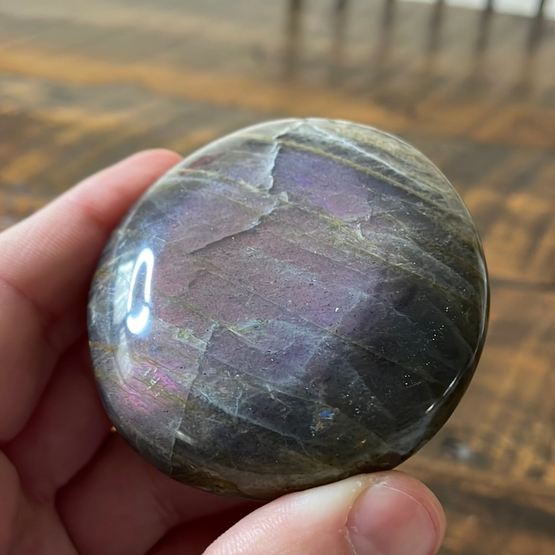 Labradorite palm stones featuring a captivating spectrum of pink, purple, green, gold and orange hues, enhanced by rainbow flashes for a unique vibrant crystal experience.