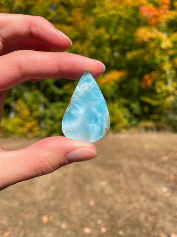 Light blue with soft white lines, tear drop in shape with polished surface. It has effects on four of the seven Chakras