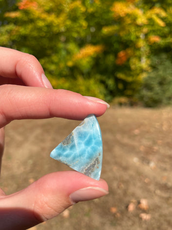 Super blue with soft white lines, shark tooth in shape with polished surface. It has effects on four of the seven Chakras