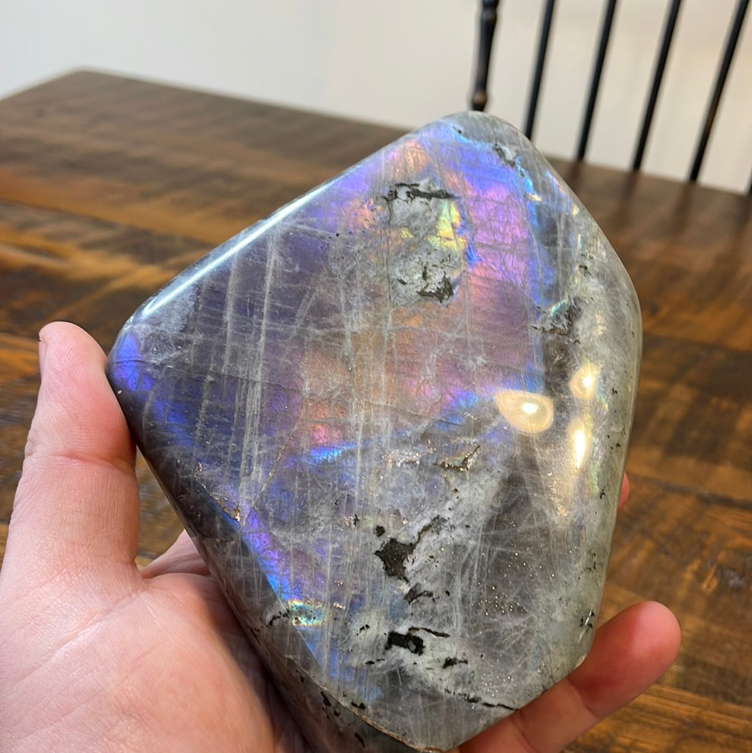 Labradorite free forms with a mesmerizing array of hues -pink, purple, green, gold,and orange, complemented by ethereal rainbow flashes, creating a vibrant enchanting crystal masterpiece.