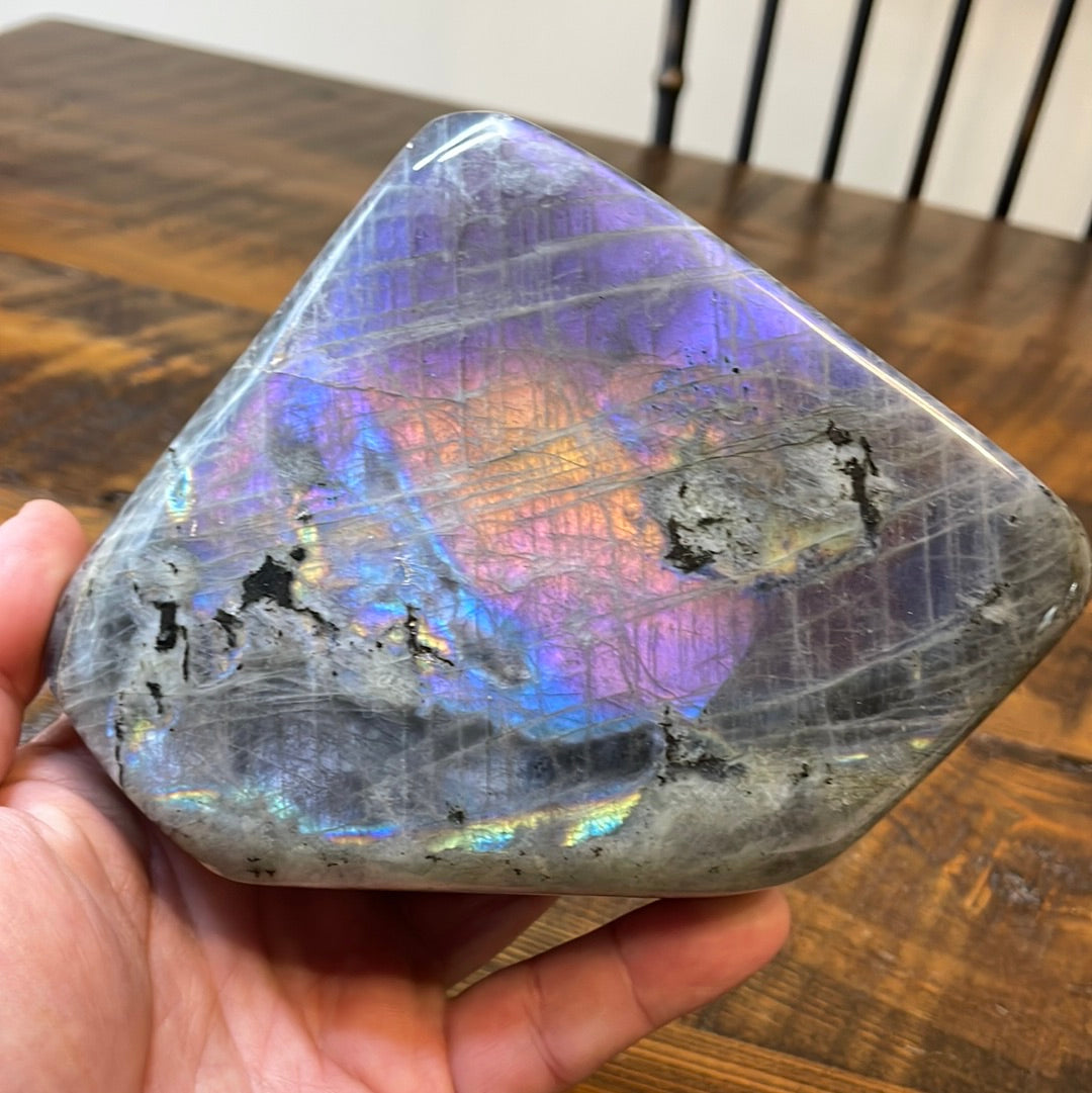 Labradorite free forms with a mesmerizing array of hues -pink, purple, green, gold,and orange, complemented by ethereal rainbow flashes, creating a vibrant enchanting crystal masterpiece.