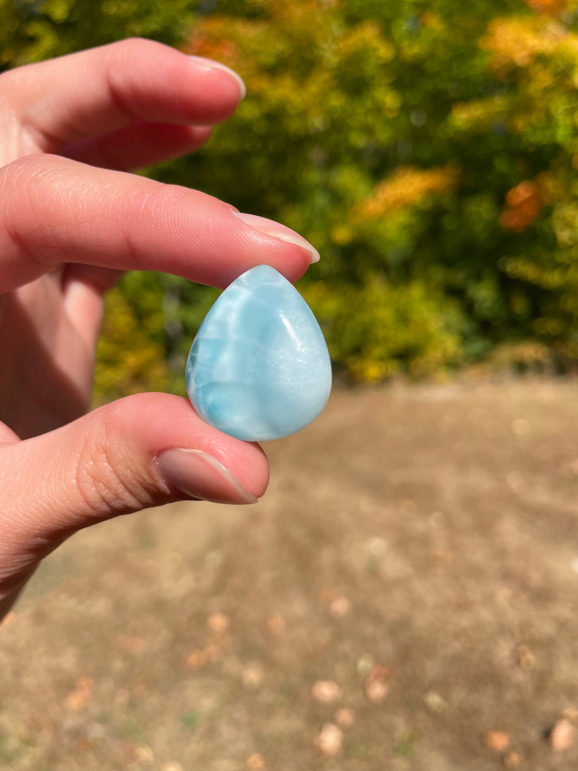 Light blue with soft white lines, Tear drop in shape, with polished surface. It has effects on four of the seven Chakras.