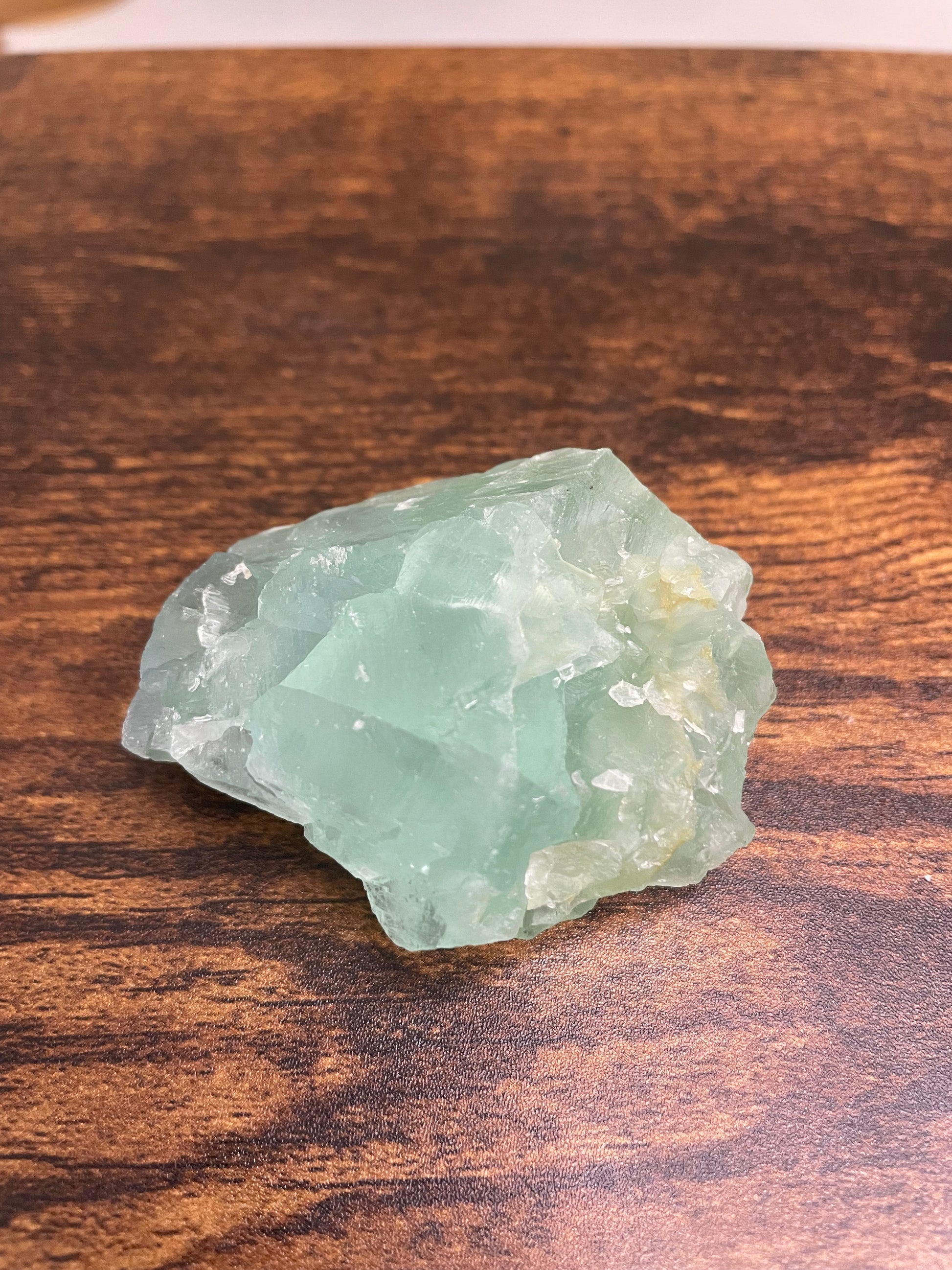 A raw Fluorite crystal in it's natural state, featuring a mix of translucent green and purple hues, reflecting the captivating beauty of this mineral's unique formations.