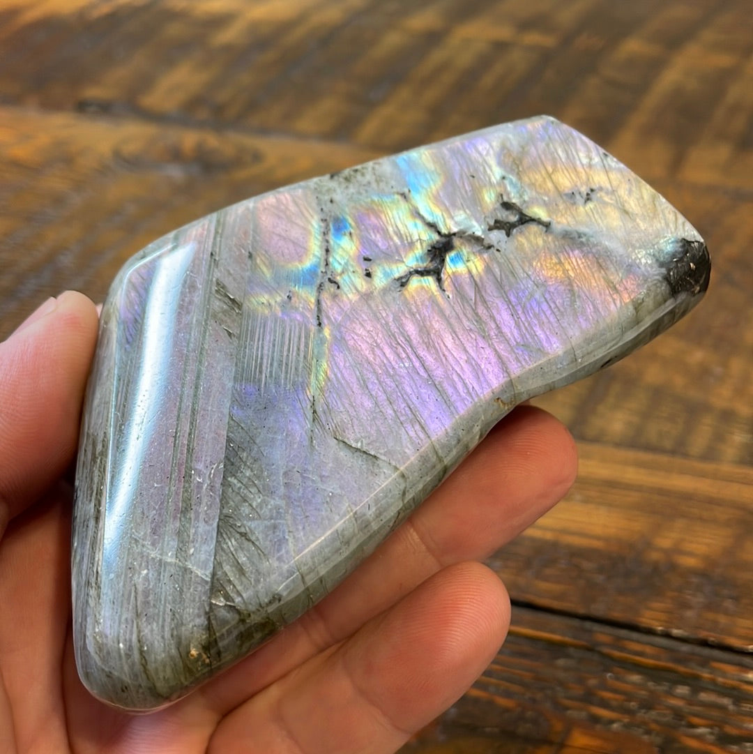 Labradorite free forms with a mesmerizing array of hues -pink, purple, green, gold,and orange, complemented by ethereal rainbow flashes, creating a vibrant enchanting crystal masterpiece.