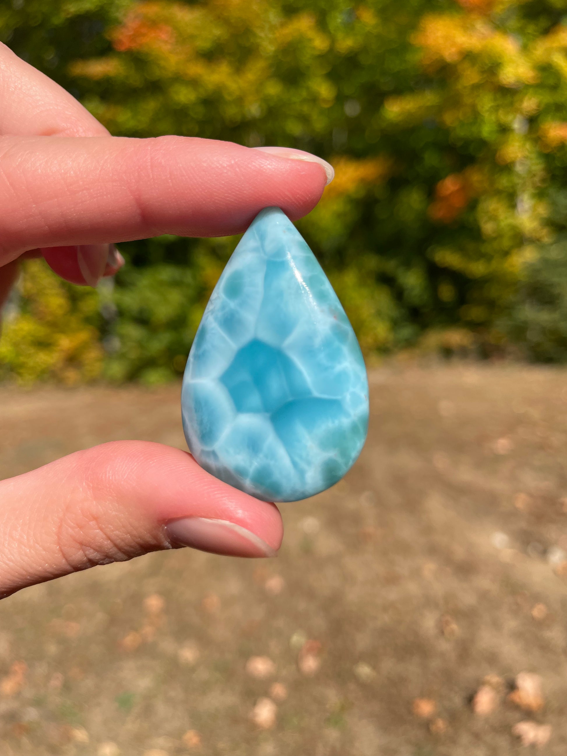 Light blue with soft white lines, Tear drop in shape with beautiful Turtle back effect, with polished surface. It has effects on four of the seven Chakras.