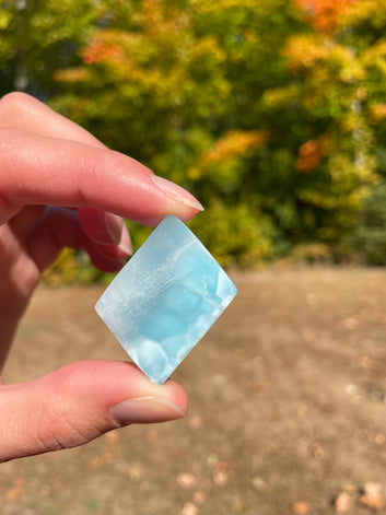 Light blue with soft white lines, Diamond in shape, with polished surface. It has effects on four of the seven Chakras.