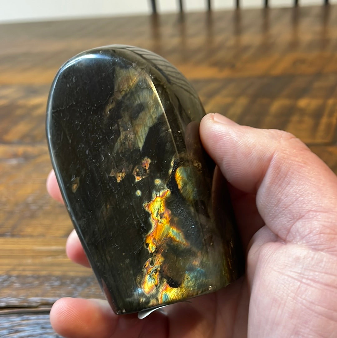 Labradorite free forms with a mesmerizing array of hues -pink, purple, green, gold,and orange, complemented by ethereal rainbow flashes, creating a vibrant enchanting crystal masterpiece.