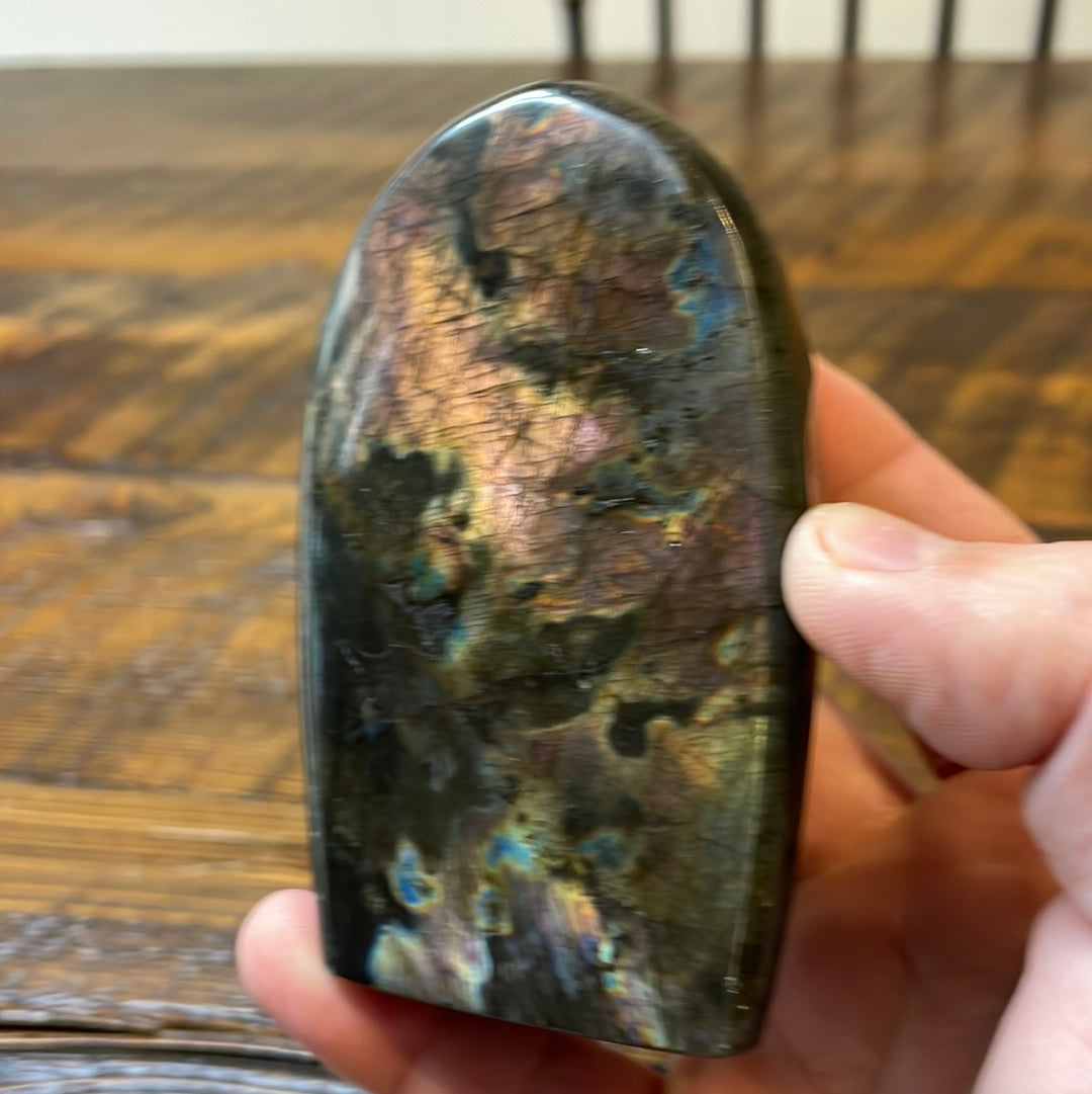 Labradorite free forms with a mesmerizing array of hues -pink, purple, green, gold,and orange, complemented by ethereal rainbow flashes, creating a vibrant enchanting crystal masterpiece.