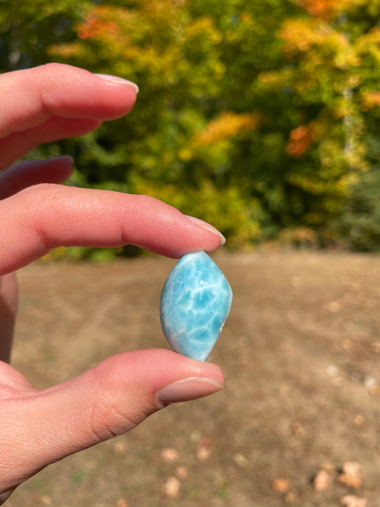 Light blue with soft white lines, tear drop in shape with polished surface. It has effects on four of the seven Chakras