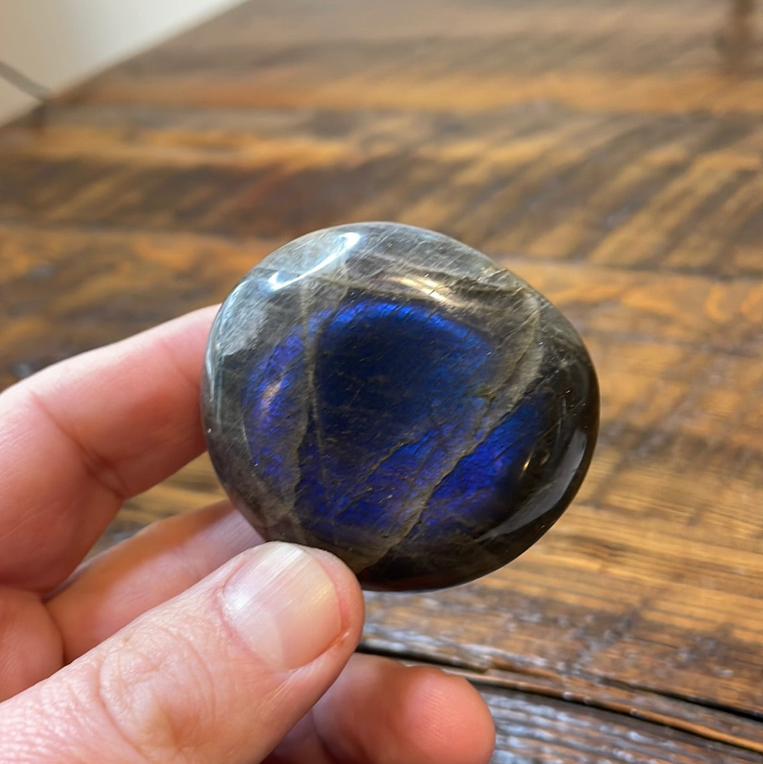 Labradorite palm stones featuring a captivating spectrum of pink, purple, green, gold and orange hues, enhanced by rainbow flashes for a unique vibrant crystal experience.