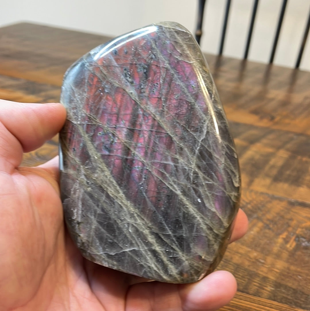 Labradorite free forms with a mesmerizing array of hues -pink, purple, green, gold,and orange, complemented by ethereal rainbow flashes, creating a vibrant enchanting crystal masterpiece.