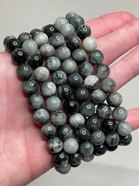 Hawk's Eye bracelet with 8mm beads, showcasing the mesmerizing blend of blue-grey hues in the hawk's eye gemstone. this bracelet combines unique aesthetics with subtle, earthy charm, making it a distinctive accessory.