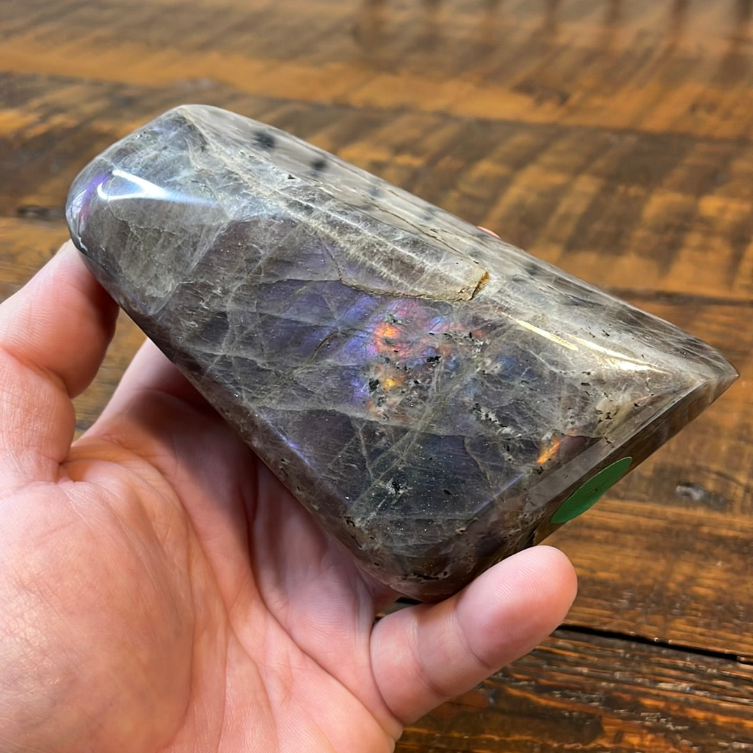 Labradorite free forms with a mesmerizing array of hues -pink, purple, green, gold,and orange, complemented by ethereal rainbow flashes, creating a vibrant enchanting crystal masterpiece.