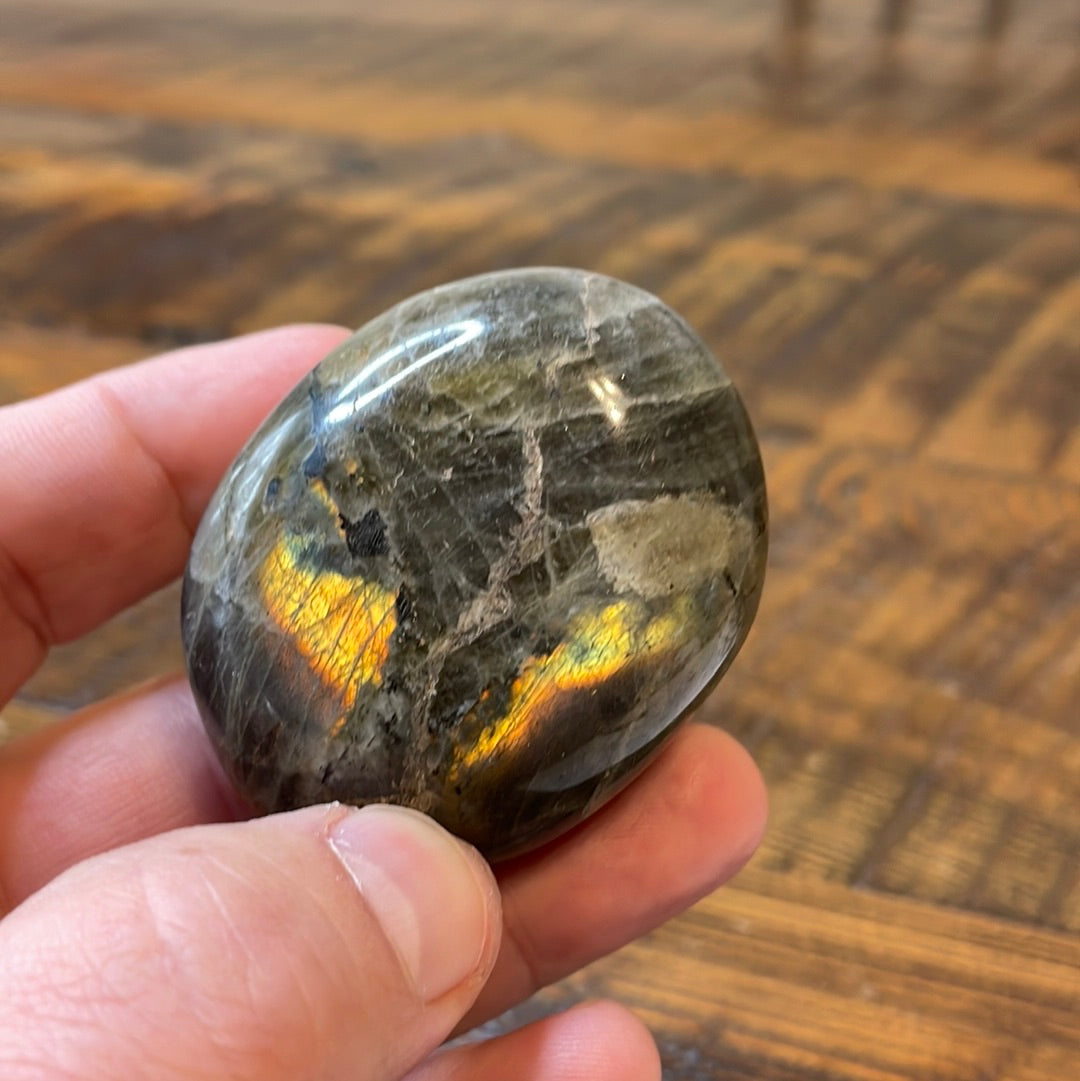 Labradorite palm stones featuring a captivating spectrum of pink, purple, green, gold and orange hues, enhanced by rainbow flashes for a unique vibrant crystal experience.