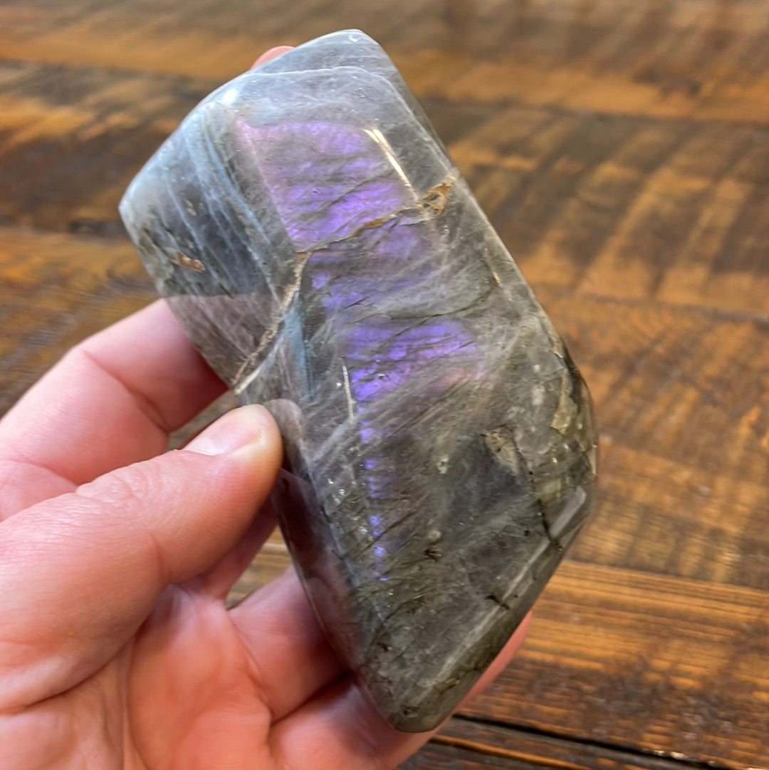 Labradorite free forms with a mesmerizing array of hues -pink, purple, green, gold,and orange, complemented by ethereal rainbow flashes, creating a vibrant enchanting crystal masterpiece.