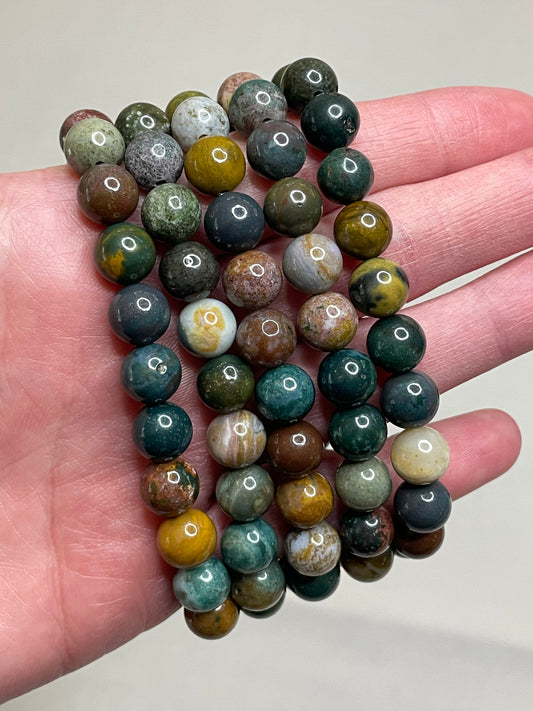 Ocean Agate bracelte featuring 8mm beads, displaying the captivating blend of oceanic blue and earthy tones in the agate crystals. this bracelet combines natural beauty with a sense of tranquility, making it a stylish and calming accessory.