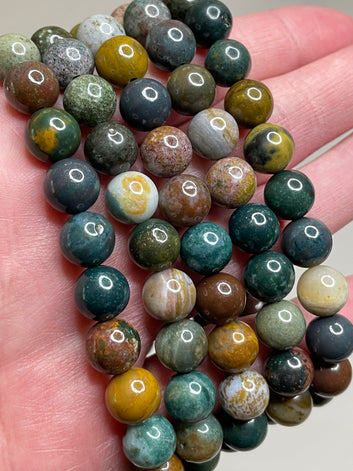 Ocean Agate bracelte featuring 8mm beads, displaying the captivating blend of oceanic blue and earthy tones in the agate crystals. this bracelet combines natural beauty with a sense of tranquility, making it a stylish and calming accessory.