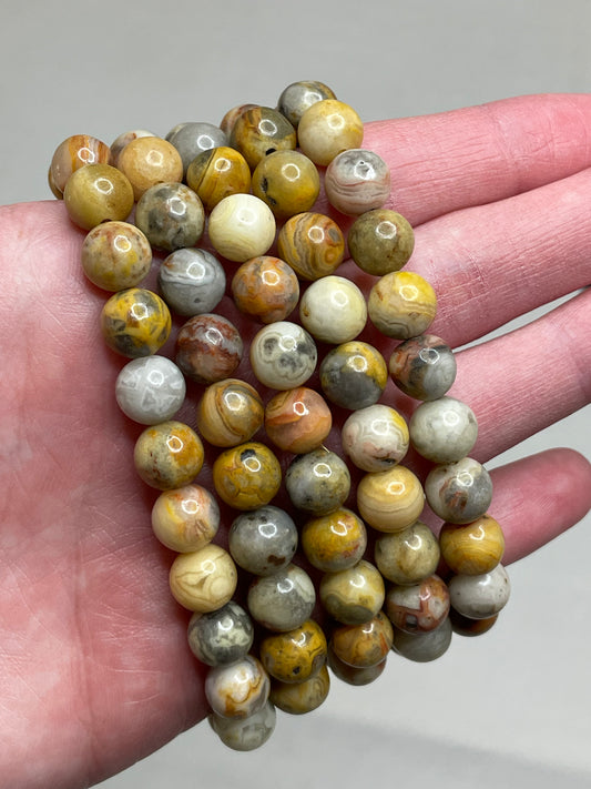Crazy Agate bracelet with 8mm beads, displaying a captivating mix of vibrant colors and patterns in the Agate stones. tThis bracelet combines natural beauty with an electric and lively aesthetic, making it a unique and stylish accessory for various occasions.