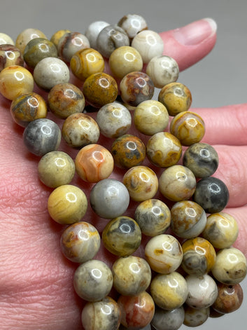 Crazy Agate bracelet with 8mm beads, displaying a captivating mix of vibrant colors and patterns in the Agate stones. tThis bracelet combines natural beauty with an electric and lively aesthetic, making it a unique and stylish accessory for various occasions.
