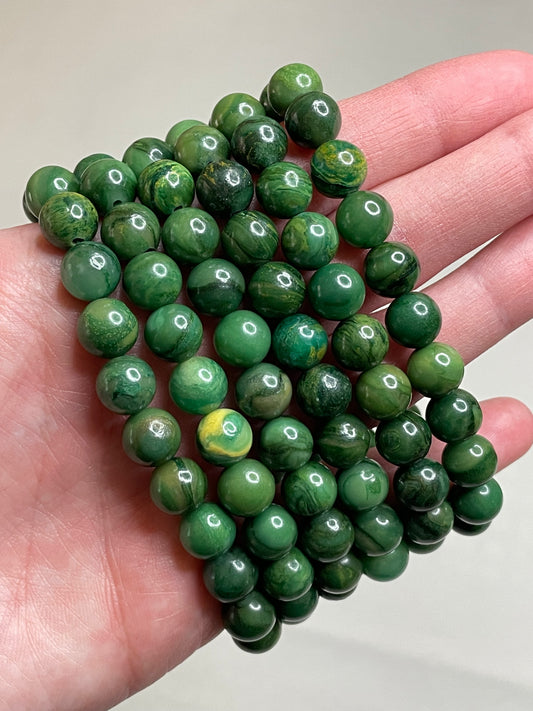 African Jade bracelet adorned with 8mm beads, showcasing the lush green hues of the African jade gemstone. This bracelet combines natural beauty with a touch of tranquility, making it a delightful accessory for any occasion.