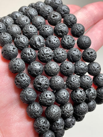 Black Lava stone bracelet with 8mm beads, showcasing the porous and textured surface of lava stones. This bracelet combines with sleek black aesthetic with the grounding properties of lava, making it a stylish and calming accessory.