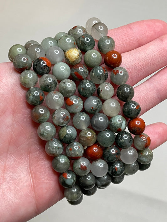 Bloodstone bracelet featuring 8mm beads, displaying the deep green hues with distinctive red specks, capturing the unique beauty of bloodstone. This bracelet combines earthy elegance with a touch of boldness, making it a striking accessory for various occasions.