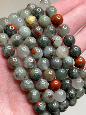 Bloodstone bracelet featuring 8mm beads, displaying the deep green hues with distinctive red specks, capturing the unique beauty of bloodstone. This bracelet combines earthy elegance with a touch of boldness, making it a striking accessory for various occasions.