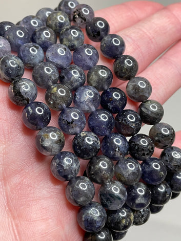 Lolite gemstone bracelet adorned with 8mm beads, displaying the mesmerizing violet-blue hues of Lolite crystals. This bracelet exudes a sense of sophistication and a touch of mystery, making it a captivating accessory for various occasions.