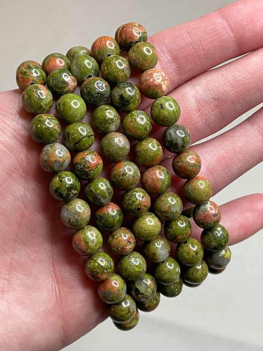 Unakite bracelet adorned with 8mm beads, showcasing the harmonious blend of pink and green hues in the Unakite gemstones. This bracelet combines natural elegance with a sense of balance, making it a charming accessory for various occasions.