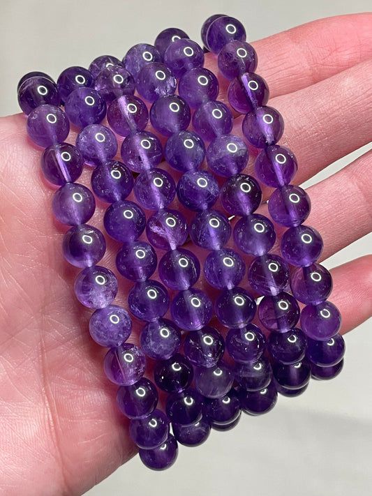 Light Amethyst bracelet adorned with 8mm beads, showcasing the soft and delicate lavender tones of amethyst crystals. This bracelet exudes a subtle elegance and a touch of serenity, making it a charming accessory for various occasions.