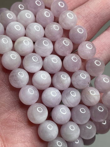 Kunzite bracelet adorned with 8mm beads, showcasing the gentle and delicate pink hues of Kunzite gemstones. This bracelet radiates elegance and a sense of compassion, making it a graceful accessory for various occasions.
