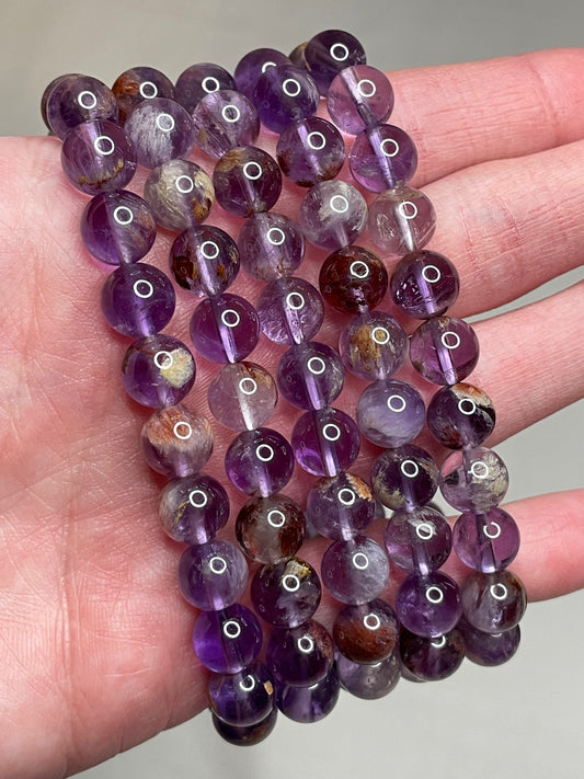 Amethyst Phantom Crystal bracelets featuring 8mm bead size, showcasing the enchanting beauty of Amethyst crystals with phantom-like inclusions, adding a touch of mystique and elegance to this unique jewelry piece.