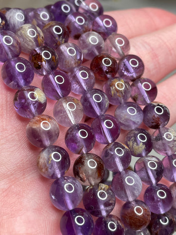 Amethyst Phantom Crystal bracelets featuring 8mm bead size, showcasing the enchanting beauty of Amethyst crystals with phantom-like inclusions, adding a touch of mystique and elegance to this unique jewelry piece.