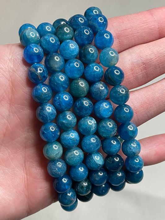 Blue Apatite bracelet featuring 8mm beads, showcasing the captivating blue hues of Apatite crystals. This bracelet combines natural beauty with a touch of vibrant energy, making it a stylish and lively accessory for various occasions.