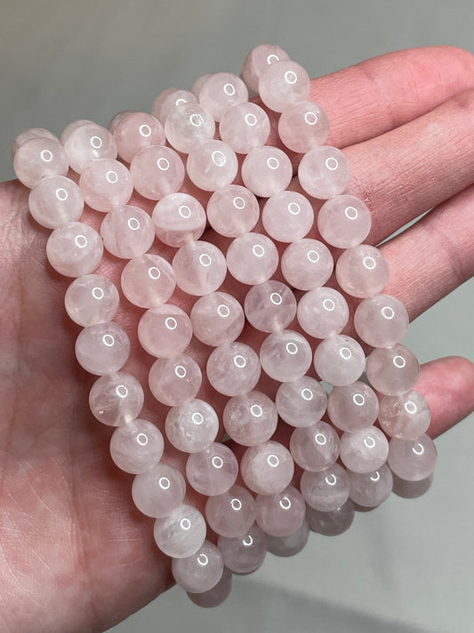 Madagascar Rose Quartz bracelet with 8mm beads, highlighting the soft and delicate pink tones of Rose Quartz crystals. This bracelet combines natural  elegance with a touch of romance, making it a charming accessory for various occasions.