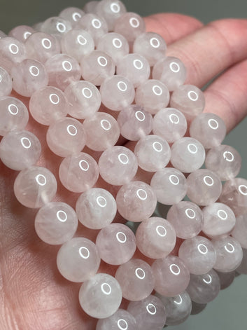 Madagascar Rose Quartz bracelet with 8mm beads, highlighting the soft and delicate pink tones of Rose Quartz crystals. This bracelet combines natural  elegance with a touch of romance, making it a charming accessory for various occasions.