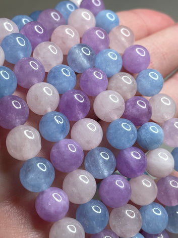 Purple Morganite bracelet adorned with 8mm beads, featuring enchanting lavender hues of purple morganite crystals. This bracelet combines elegance with a touch of serenity, making it a captivating accessory for any occasion.
