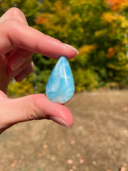 Light blue with soft white lines, Tear drop in shape, with polished surface. It has effects on four of the seven Chakras.
