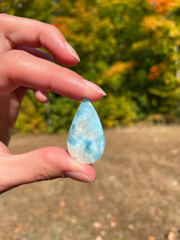 Light blue with soft white lines, Tear drop in shape, with polished surface. It has effects on four of the seven Chakras.