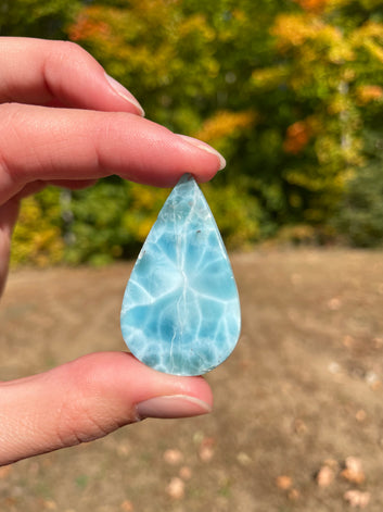 Light blue with soft white lines, Tear drop in shape, with polished surface. It has effects on four of the seven Chakras.