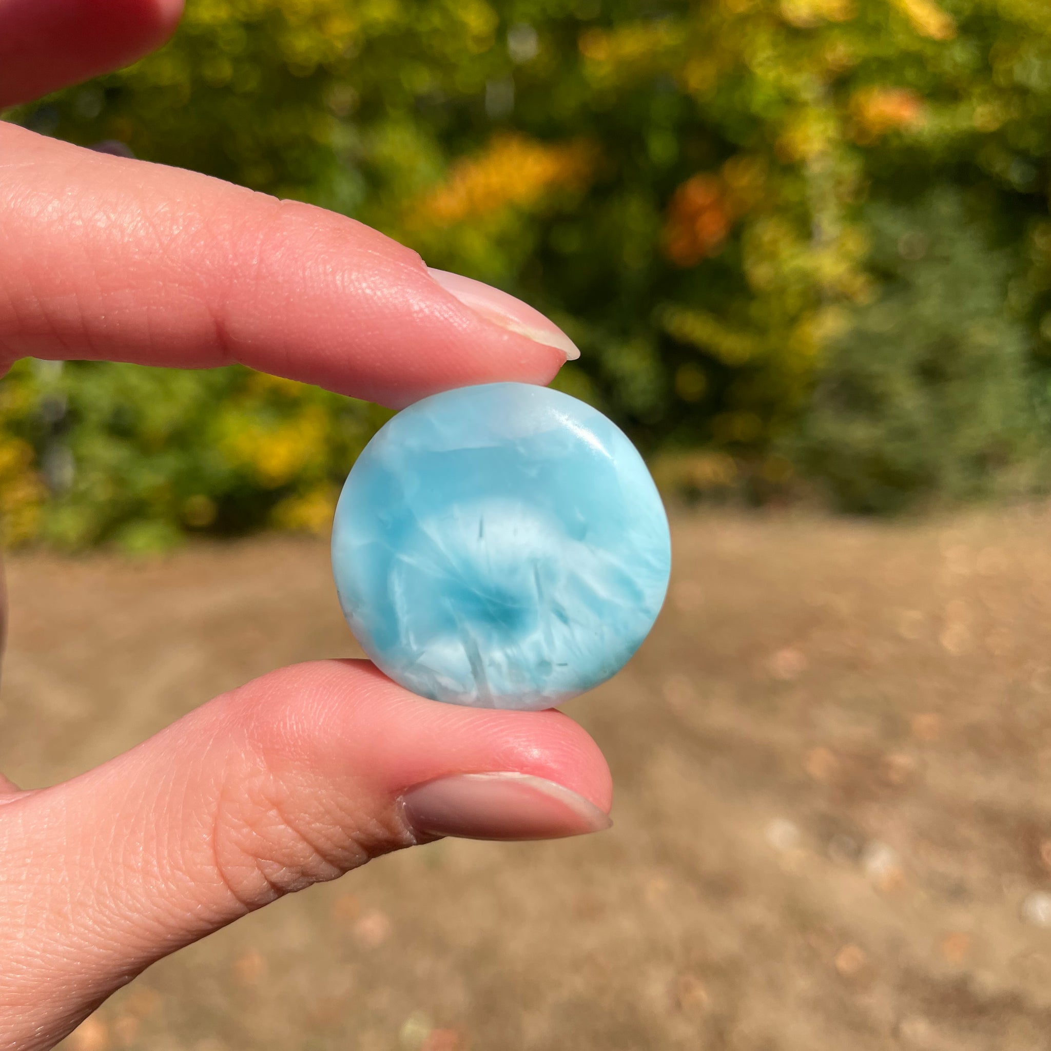 Light blue with soft white lines, round in shape with polished surface. It has effects on four of the seven Chakras