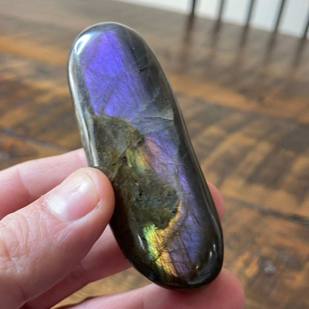 Labradorite palm stones featuring a captivating spectrum of pink, purple, green, gold and orange hues, enhanced by rainbow flashes for a unique vibrant crystal experience. 