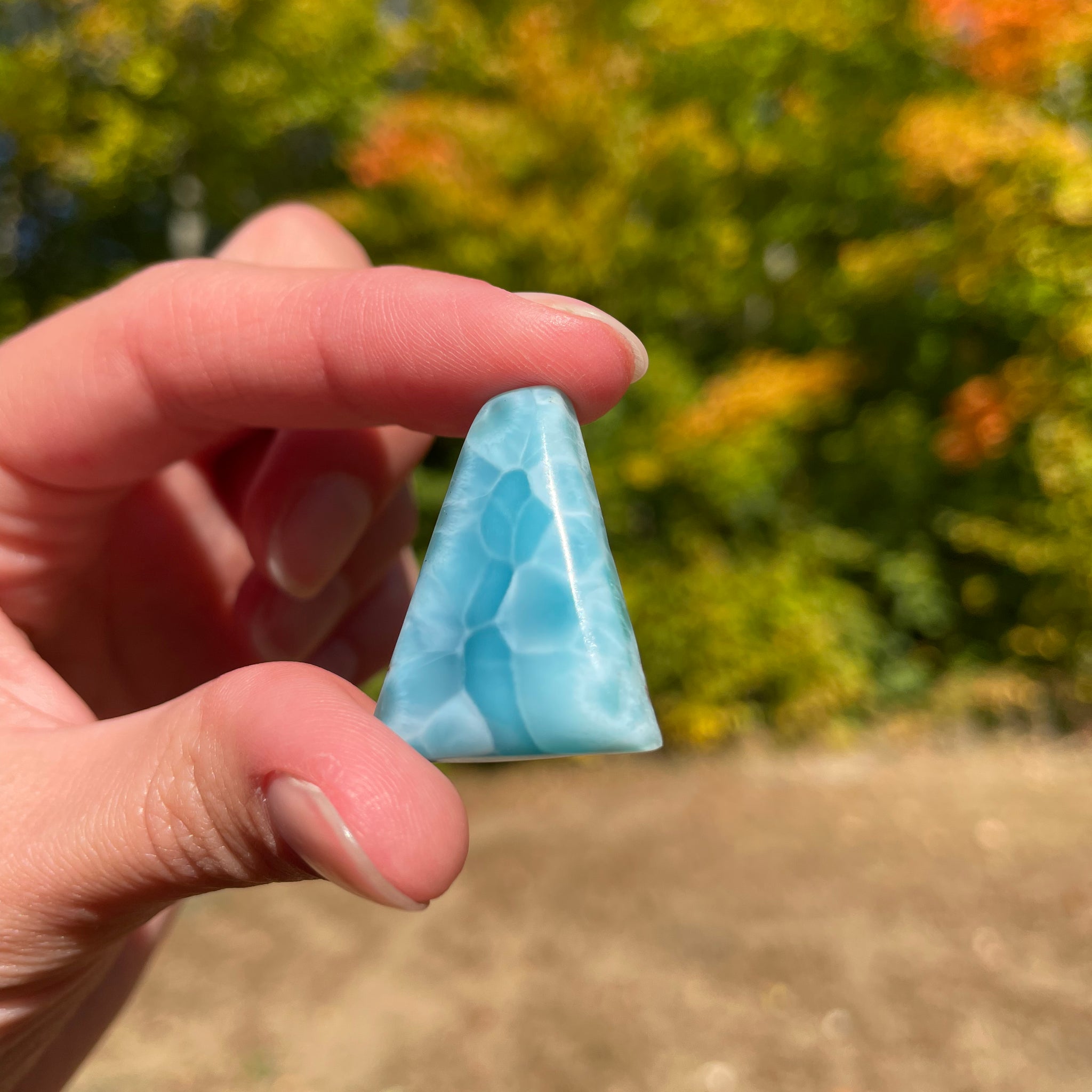 Light blue with soft white lines, triangular in shape with polished surface. It has effects on four of the seven Chakras