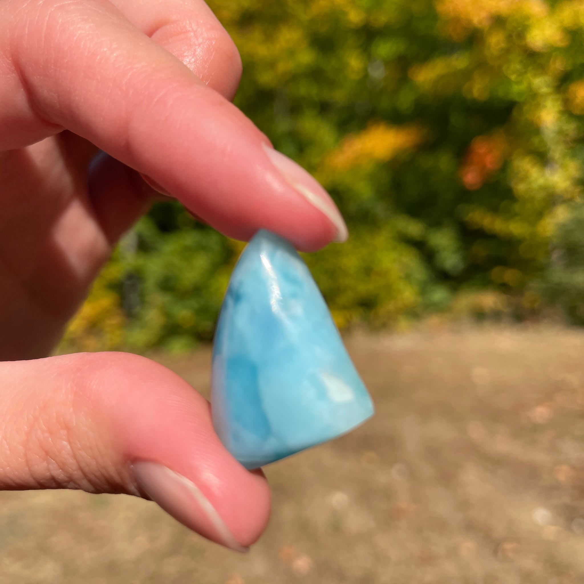 Light blue with soft white lines. Shark fin in shape, with polished surface. It has effects on four of the seven Chakras.