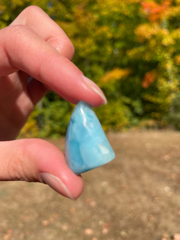 Light blue with soft white lines. Shark fin in shape, with polished surface. It has effects on four of the seven Chakras.