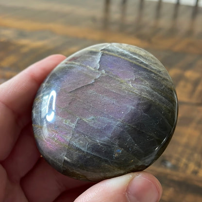 Labradorite palm stones featuring a captivating spectrum of pink, purple, green, gold and orange hues, enhanced by rainbow flashes for a unique vibrant crystal experience. 